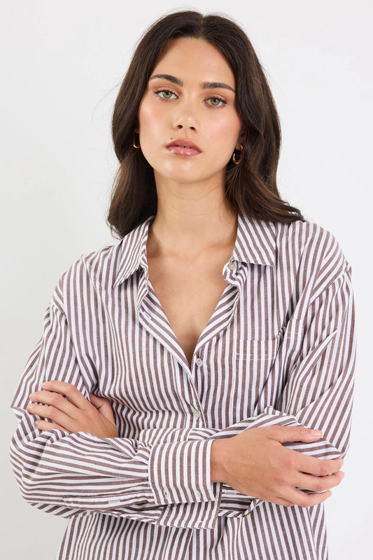 Woman wearing a striped shirt against a white background
