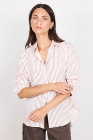Woman wearing a striped shirt against a plain background