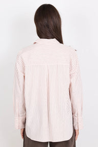Person wearing a striped shirt on a plain background