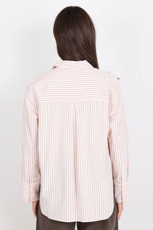 Person wearing a striped shirt on a plain background
