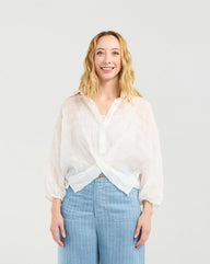 Woman wearing Zafina Heidi white blouse and light blue striped pants on a white background