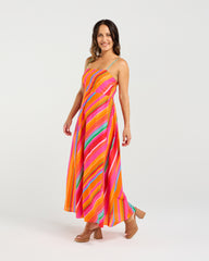 Woman wearing a colorful striped dress on a white background