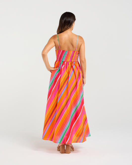 Woman wearing a colorful striped dress on a white background