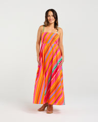 Woman wearing a colorful striped dress on a white background