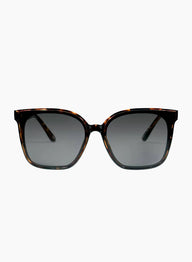 Sunglasses with tortoiseshell frame and dark lenses on a white background