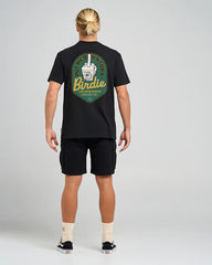 Person wearing a black t-shirt with a logo on the back against a gray background