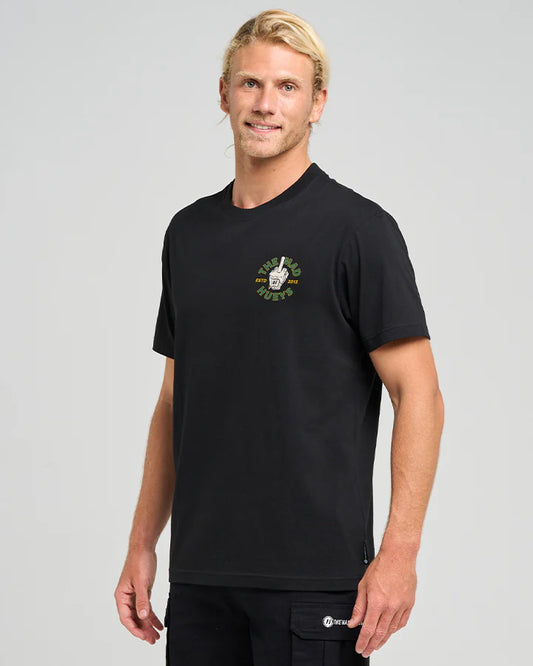 Man wearing a black t-shirt with a logo on a gray background