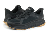 Black running shoes with brown soles on a white background