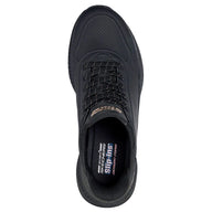 Black sneaker with 'Skechers' branding on a white background