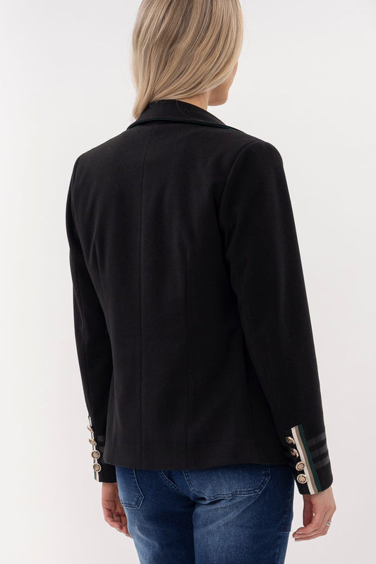 Black blazer with decorative buttons worn by a person on a white background