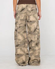 Camouflage pants worn by a person on a white background