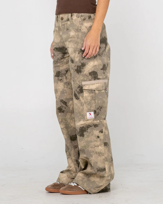 Camouflage pants worn by a person on a white background