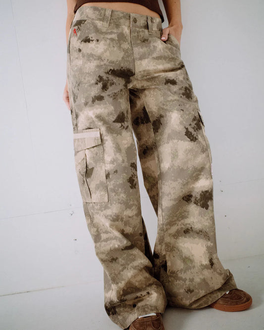 Camouflage pants worn by a person on a white background