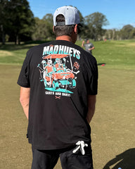 Person wearing a black t-shirt with a colorful graphic on the back, standing on a grassy field.