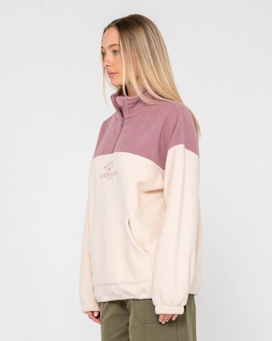 Person wearing a two-tone jacket with a visible brand logo on a white background