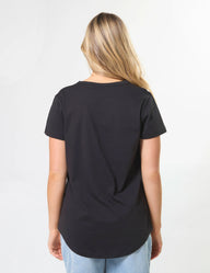 Person wearing a black t-shirt on a plain background