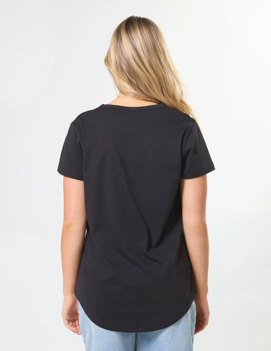 Person wearing a black t-shirt on a plain background