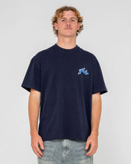 Person wearing a navy blue t-shirt with a logo on a light gray background