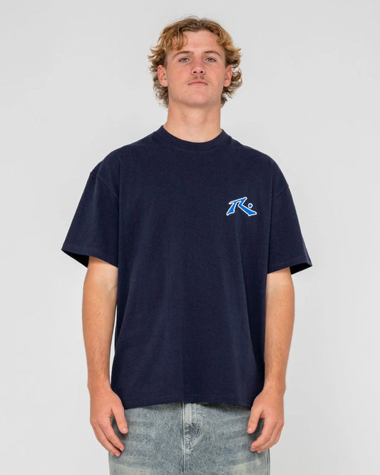 Person wearing a navy blue t-shirt with a logo on a light gray background