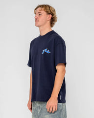 Person wearing a navy blue t-shirt with a logo on a light gray background