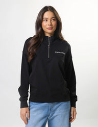 Woman wearing a black pullover with a logo on a white background