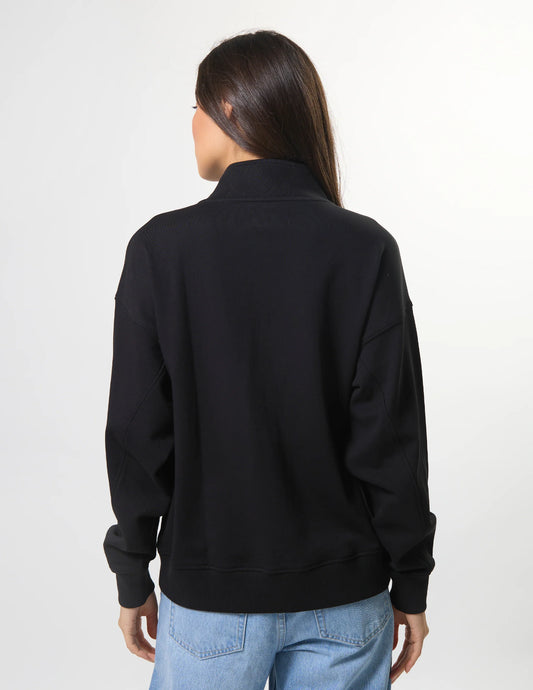 Person wearing a black jacket on a white background