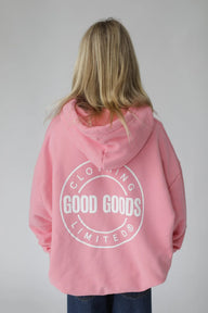 Person wearing a pink hoodie with 'Good Goods Limited' logo on the back against a gray background