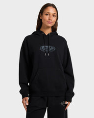 Person wearing a black hoodie with a logo on a gray background