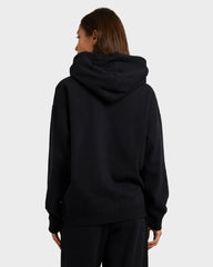 Person wearing a black hoodie from behind on a light gray background