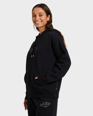 Person wearing a black hoodie with a visible brand logo on a white background