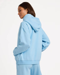 Person wearing a light blue hoodie on a white background