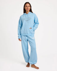 Person wearing a light blue hoodie and pants set on a white background