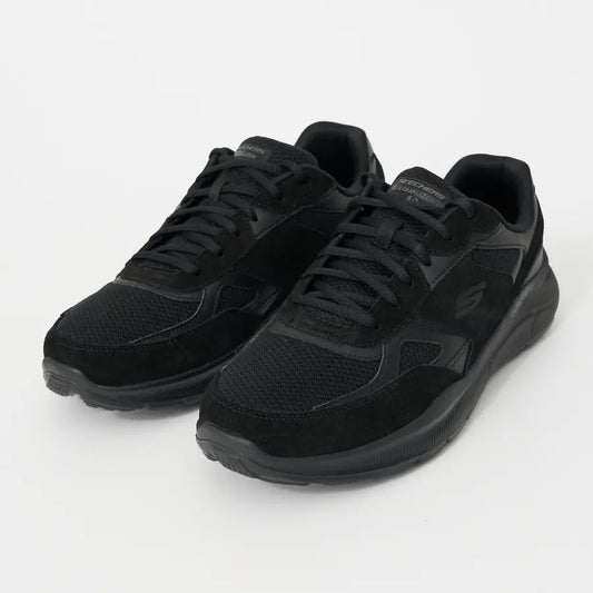 Pair of black sneakers on a white background