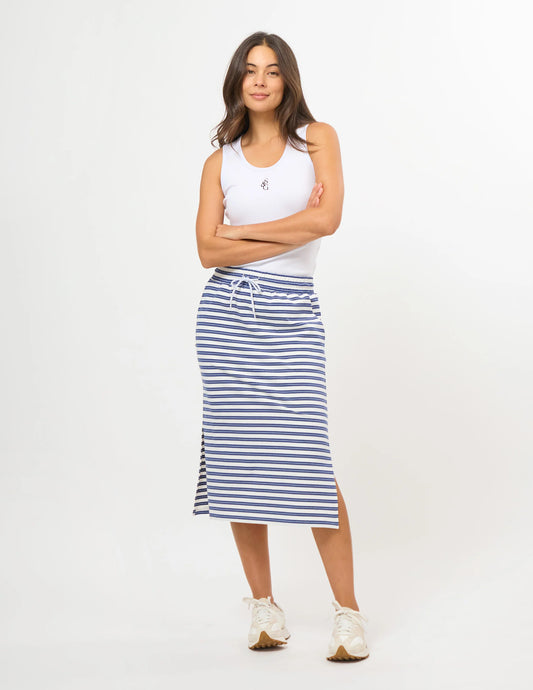 A person wearing a blue and white horizontally striped midi skirt with a white drawstring waist and side pockets, paired with white sneakers, against a plain white studio background.