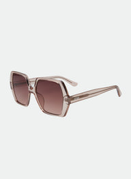 Sunglasses with a transparent frame and brown gradient lenses on a light gray background