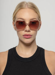 Woman wearing large sunglasses with a plain background