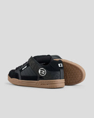 Black and brown sneaker with a visible brand logo on a light gray background
