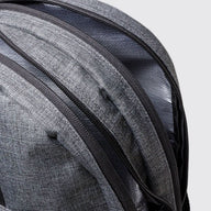 Grey school bag showing zip detail with grey background