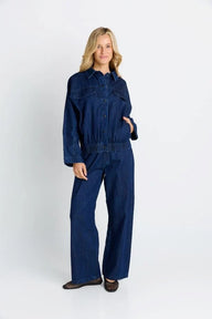 Woman wearing a blue denim outfit on a white background