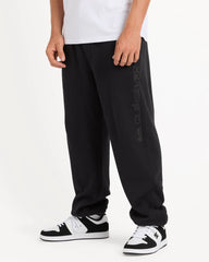 Person wearing black pants with a brand logo on a white background