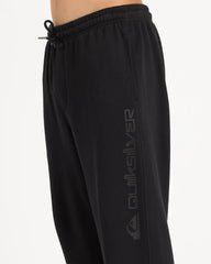 Black sweatpants with a brand logo on a light gray background
