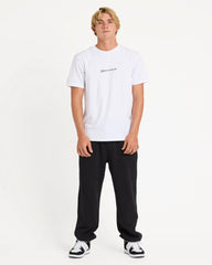 Person wearing a white t-shirt and black pants on a white background