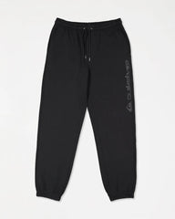 Black sweatpants with a brand logo on a light gray background