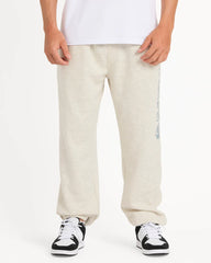 Person wearing beige sweatpants with a logo on a white background