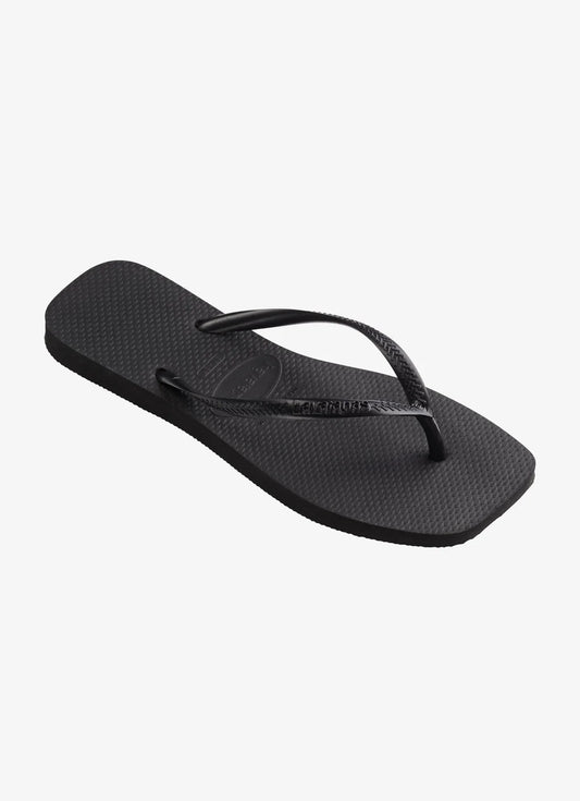 Black sandal with a thin strap on a white background