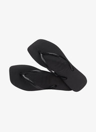 Pair of black flip-flops on a white background