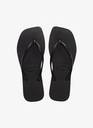 Pair of black flip-flops on a white background