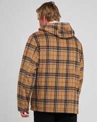 Person wearing a plaid jacket from behind on a gray background