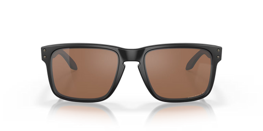 Sunglasses with a black frame and brown lenses on a reflective surface