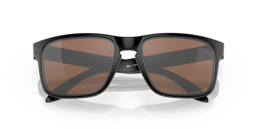 Black sunglasses with brown lenses on a black background